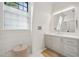 Bright bathroom featuring white shiplap walls, marble countertop, and modern fixtures at 922 Kincade Dr, Mount Pleasant, SC 29464