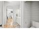 Bathroom featuring hardwood floors, an adjacent view to a bedroom, and shiplap walls at 922 Kincade Dr, Mount Pleasant, SC 29464