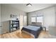 Cozy bedroom features a comfortable bed, bookshelf, hardwood floors, and natural light at 922 Kincade Dr, Mount Pleasant, SC 29464