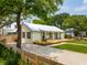 Charming home exterior with lush landscaping, metal roof, and a circular driveway at 922 Kincade Dr, Mount Pleasant, SC 29464