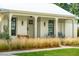Inviting front porch with metal roof, featuring elegant columns and cozy seating at 922 Kincade Dr, Mount Pleasant, SC 29464