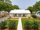 Landscaped front yard with stone walkway and lush lawn leading to a charming single-story home at 922 Kincade Dr, Mount Pleasant, SC 29464