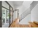 Bright hallway with hardwood floors, staircase, and glass doors leading to the patio at 922 Kincade Dr, Mount Pleasant, SC 29464