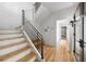 Hallway view features wood stairs with black steel handrail and view into bedroom with wooden floor at 922 Kincade Dr, Mount Pleasant, SC 29464