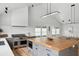 Open-concept kitchen with light-toned wood floors, butcher block island, and stainless steel appliances at 922 Kincade Dr, Mount Pleasant, SC 29464