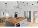 Open kitchen/dining room with stainless fridge, butcher block island, and vaulted ceilings at 922 Kincade Dr, Mount Pleasant, SC 29464
