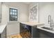 Bright laundry room features front load washer and dryer and sink with stylish faucet and hardware at 922 Kincade Dr, Mount Pleasant, SC 29464
