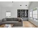 Comfortable living room with a gray sofa, built-in shelving, and natural light at 922 Kincade Dr, Mount Pleasant, SC 29464