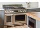 Close up view of a signature stainless steel oven and microwave with grey cabinets at 922 Kincade Dr, Mount Pleasant, SC 29464