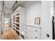 Bright walk-in closet featuring custom shelving, drawers, and a hardwood floor at 922 Kincade Dr, Mount Pleasant, SC 29464