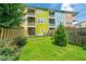 A colorful townhome with a well-maintained grassy backyard and wooden fence offers a great outdoor space at 9305 Sweetbay Ct, Ladson, SC 29456