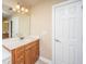 Bathroom vanity with a mirror and lighting, next to a doorway at 9305 Sweetbay Ct, Ladson, SC 29456