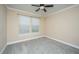 Bedroom with neutral walls, gray carpet, a ceiling fan and white trim around the window at 9305 Sweetbay Ct, Ladson, SC 29456