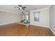 Spacious bonus room featuring hardwood floors, two ceiling fans, and natural light at 9305 Sweetbay Ct, Ladson, SC 29456