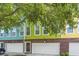 The townhome has a white garage door, red brick accents and is painted light green at 9305 Sweetbay Ct, Ladson, SC 29456
