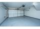 Clean, empty garage with epoxy flooring, and white door provides ample parking and storage space at 9305 Sweetbay Ct, Ladson, SC 29456