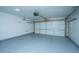Spacious garage features epoxy flooring, a white door, overhead lighting, and ample room for parking and storage at 9305 Sweetbay Ct, Ladson, SC 29456