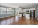 Bright dining area and kitchen featuring white cabinets, stainless steel appliances and hardwood floors at 9305 Sweetbay Ct, Ladson, SC 29456