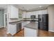 Modern kitchen featuring white cabinets, stainless steel appliances, and a central island at 9305 Sweetbay Ct, Ladson, SC 29456