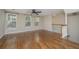 Bright living room featuring hardwood floors, natural light from multiple windows, and a ceiling fan at 9305 Sweetbay Ct, Ladson, SC 29456