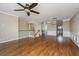 Open-concept living room with hardwood floors, modern lighting, and adjacent kitchen at 9305 Sweetbay Ct, Ladson, SC 29456