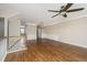 Open-concept living room with hardwood floors, modern lighting, and a staircase at 9305 Sweetbay Ct, Ladson, SC 29456