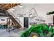 Spacious interior with a tractor, farm decorations, wooden beams, stairs, and open floor plan at 99 French Garden Cir, Summerville, SC 29486