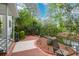 Scenic backyard featuring a brick patio, wrought iron fencing, mature trees, and a tranquil water view at 1025 Mathis Ferry Rd, Mount Pleasant, SC 29464