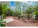 Relaxing brick patio with outdoor seating surrounded by lush greenery and mature landscaping at 1025 Mathis Ferry Rd, Mount Pleasant, SC 29464