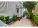 Well-manicured yard with lush plants, sidewalk and white picket fence at 1025 Mathis Ferry Rd, Mount Pleasant, SC 29464