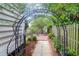 A backyard scene features a metal archway leading to an outdoor seating area at 1025 Mathis Ferry Rd, Mount Pleasant, SC 29464