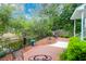 Brick patio overlooking a serene water feature with mature trees and decorative outdoor seating at 1025 Mathis Ferry Rd, Mount Pleasant, SC 29464