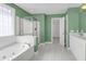 Bright bathroom featuring a soaking tub and glass shower at 1025 Mathis Ferry Rd, Mount Pleasant, SC 29464