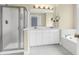 Bright bathroom featuring double vanity, soaking tub, and glass enclosed shower at 1025 Mathis Ferry Rd, Mount Pleasant, SC 29464