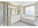 Bright bathroom featuring double vanity, soaking tub, and glass enclosed shower at 1025 Mathis Ferry Rd, Mount Pleasant, SC 29464