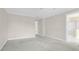 Large bedroom with bright, adjacent bathroom and neutral walls at 1025 Mathis Ferry Rd, Mount Pleasant, SC 29464