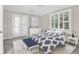Well-lit bedroom with white french doors and a ceiling fan at 1025 Mathis Ferry Rd, Mount Pleasant, SC 29464