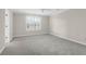 Neutral bedroom with bright window, plush carpeting, ceiling fan, and ample space at 1025 Mathis Ferry Rd, Mount Pleasant, SC 29464