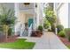 Inviting home with a well-manicured lawn, a vibrant turquoise door, and a classic staircase at 1025 Mathis Ferry Rd, Mount Pleasant, SC 29464