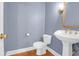 Elegant powder room features a pedestal sink, blue walls, and hardwood floors at 1025 Mathis Ferry Rd, Mount Pleasant, SC 29464