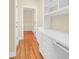 Bright hallway featuring hardwood floors, built-in shelving and storage, and neutral paint at 1025 Mathis Ferry Rd, Mount Pleasant, SC 29464
