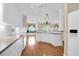 Bright open kitchen with white cabinets, island, and hardwood floors creates a great room atmosphere at 1025 Mathis Ferry Rd, Mount Pleasant, SC 29464
