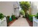 Side yard with a walkway leading to a private outdoor space, complemented by manicured greenery at 1025 Mathis Ferry Rd, Mount Pleasant, SC 29464