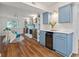 Open-concept living room with hardwood floors, a fireplace, and a convenient bar area at 103 Sylvan Ter, Summerville, SC 29485