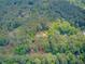 Aerial view showcasing a home nestled in a densely wooded neighborhood with verdant greenery and scattered residences at 107 Kimberwicke Dr, Summerville, SC 29483