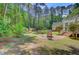 Lush backyard featuring a brick fire pit and a covered patio at 107 Kimberwicke Dr, Summerville, SC 29483