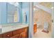 Bright bathroom with granite counters, blue walls, and a second bathroom in view at 107 Kimberwicke Dr, Summerville, SC 29483