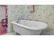 Close-up of a classic standalone bathtub with hardwood floors and decorative walls at 107 Kimberwicke Dr, Summerville, SC 29483
