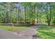 The driveway winds through a beautiful property with mature trees and landscaping at 107 Kimberwicke Dr, Summerville, SC 29483