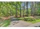 Long driveway leading to a secluded home surrounded by mature trees and lush greenery at 107 Kimberwicke Dr, Summerville, SC 29483